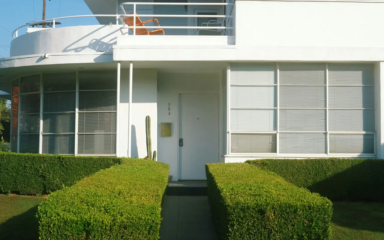 A white Southern California home with clean architectural lines and landscaped entry