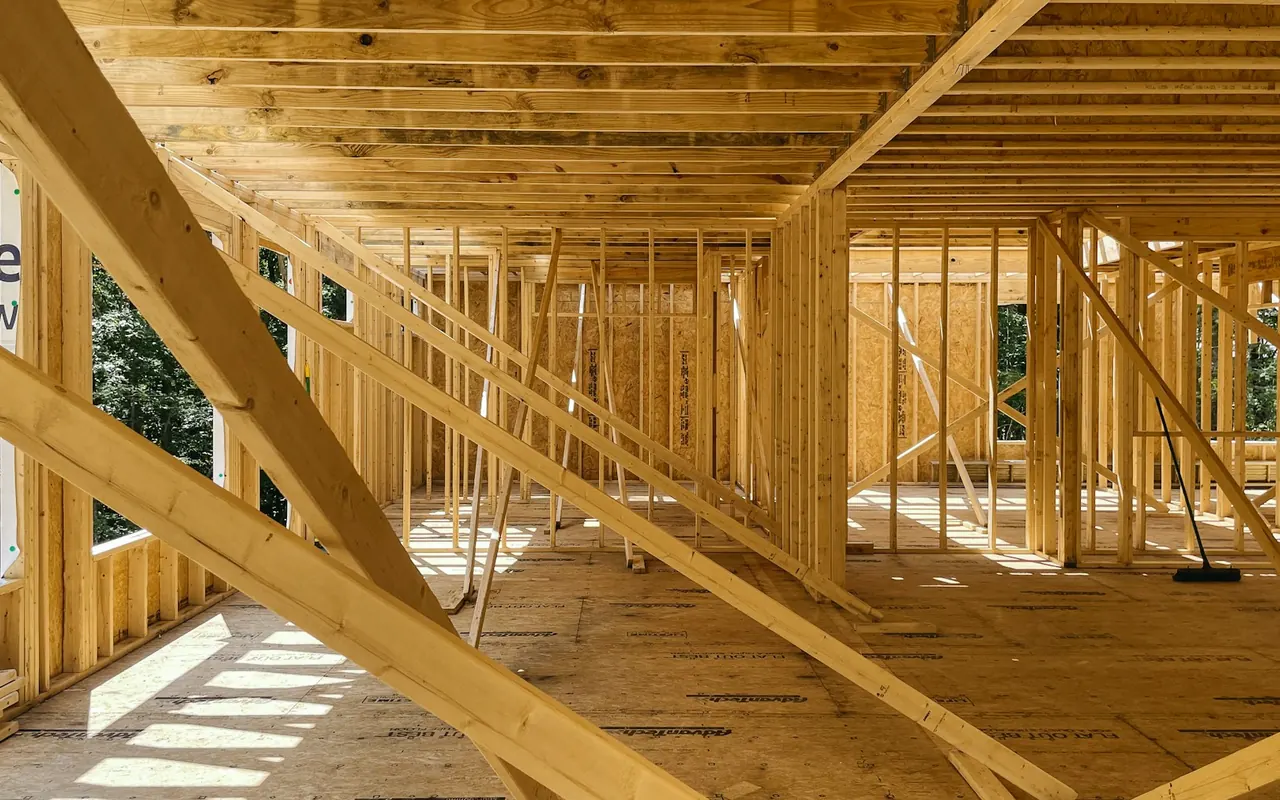 A residential construction site with exposed wood framing